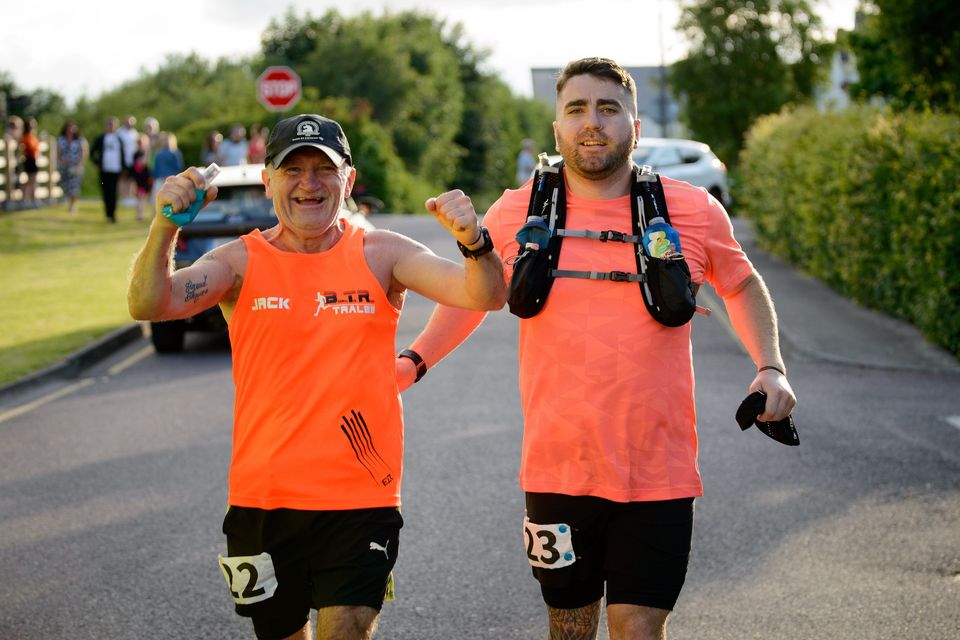 A father & son moment for the ages: Tralee's Jack Moriarty and his son Fergal pictured crossing the finish line of the Tralee 100k on Saturday evening. Photo by Barry Fitzgerald.